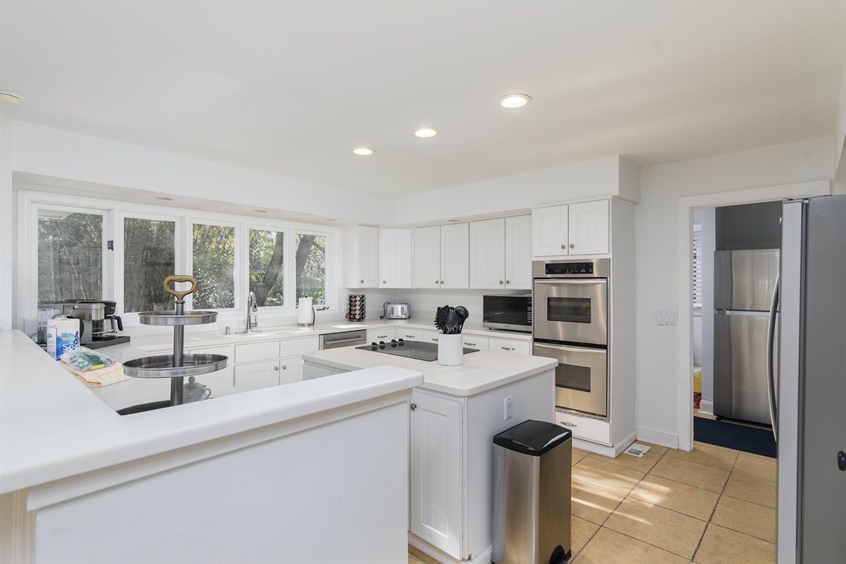 Kitchen features double ovens and 2 fridges