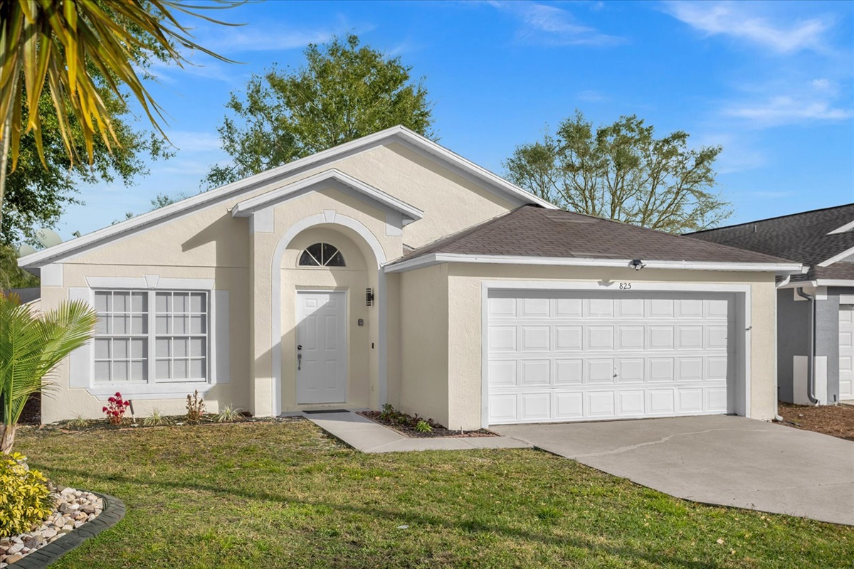 Single-level home with a two-car driveway and a well-maintained lawn