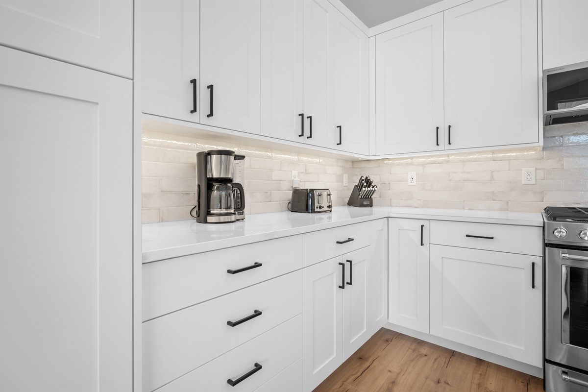 Fully stocked kitchen with coffee maker and ample counter space for easy meal prep.
