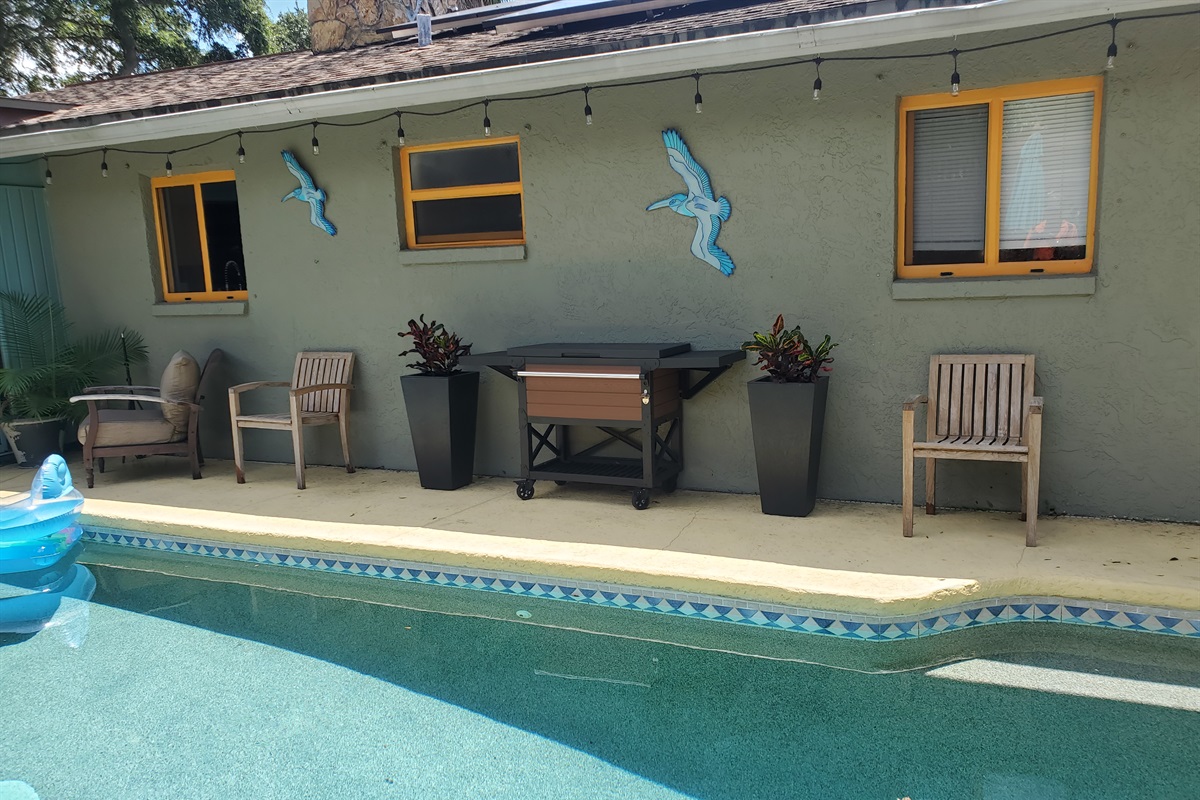 Lots of teak chairs, and beautiful landscaping. We  have set this cooler station for all your beverages.