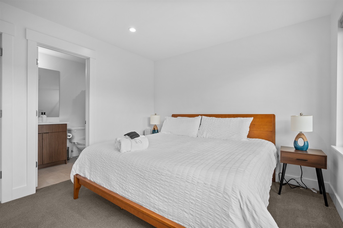 King bedroom with attached private bath and contemporary design.