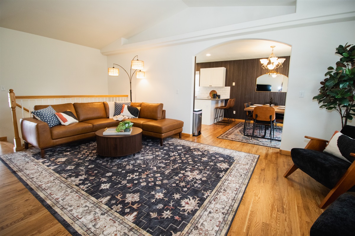 Enjoy a spacious and warm upper level with high-ceilings, moody finishes, smart tv, and comfortable seating