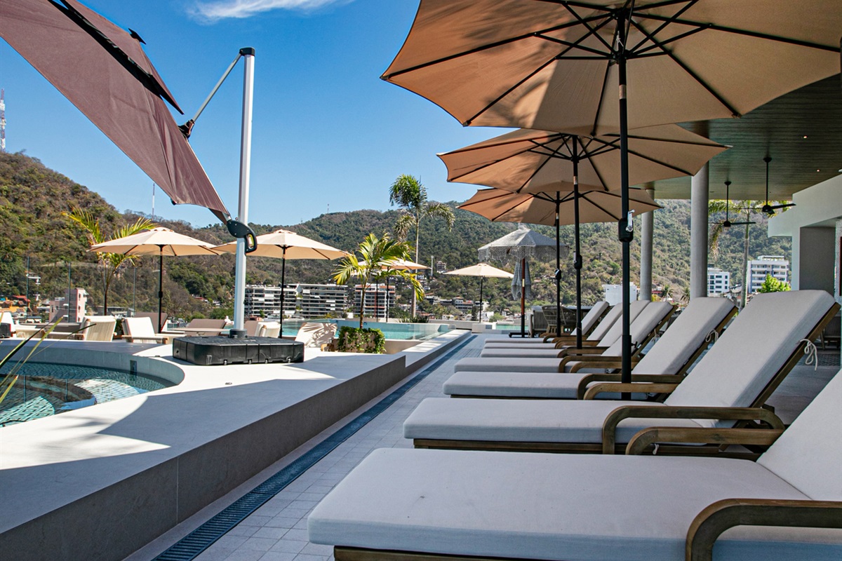 A peaceful rooftop retreat—stretch out on poolside loungers and soak up the sun in pure relaxation.