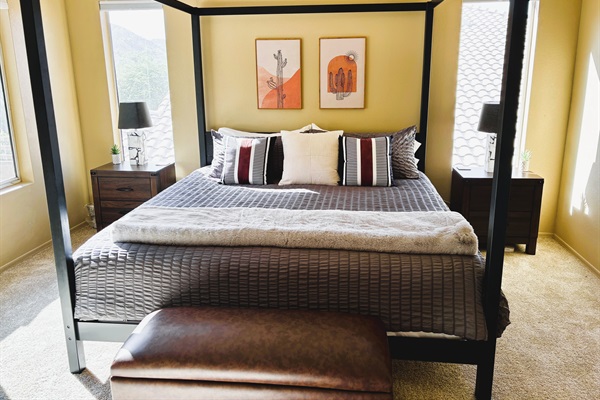 Primary bedroom with ensuite bathroom, Smart TV, walk in closet, private balcony, ceiling fan, linens and remote workstation