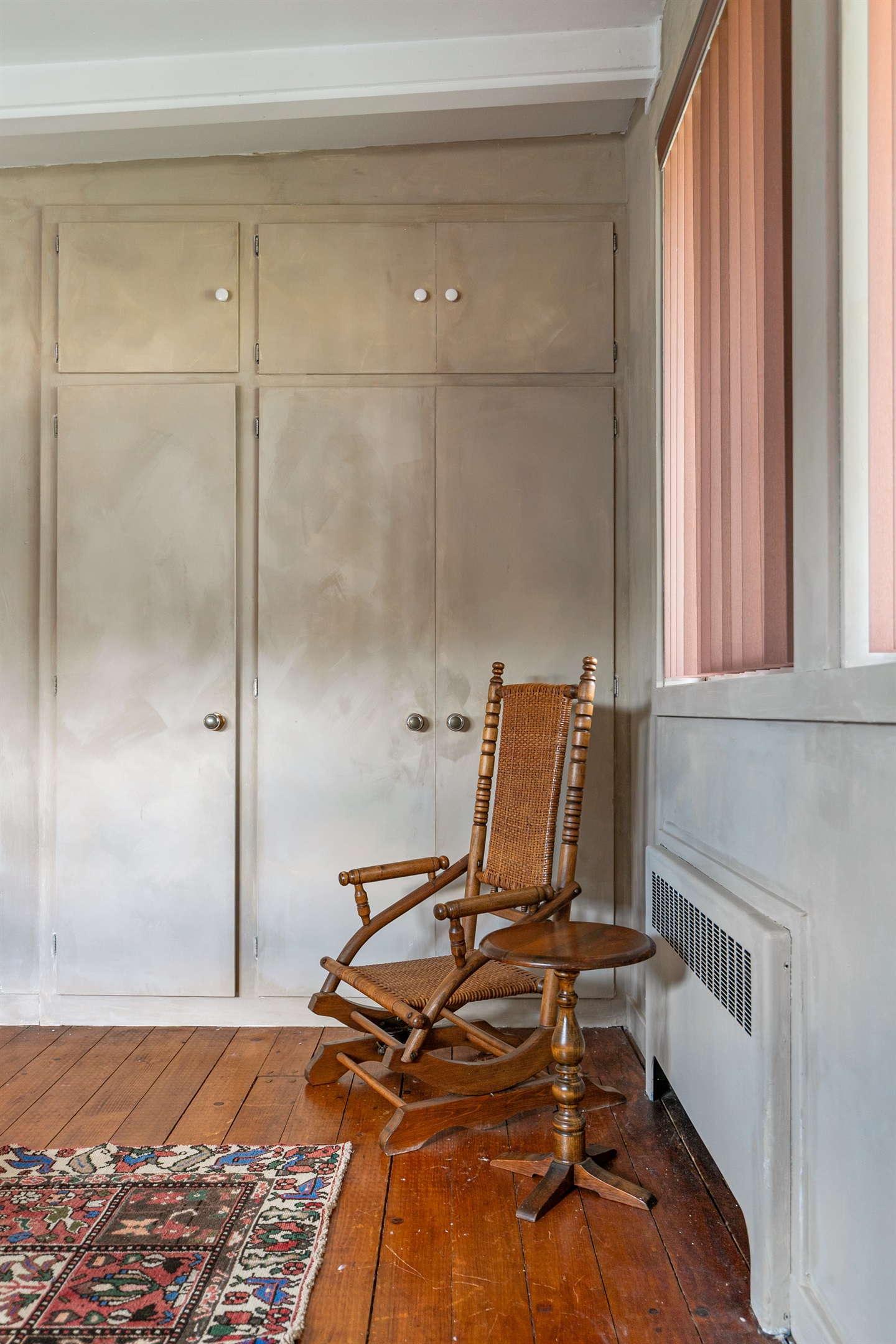 A modern rocking chair adds a cozy touch to the home’s stylish design.