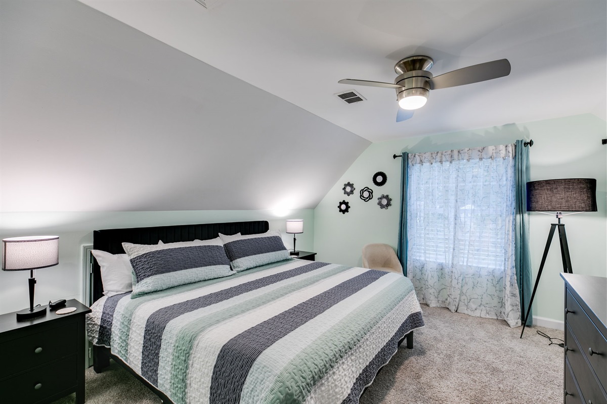 Drift off under the ceiling fan’s gentle breeze and wake up refreshed in a serene, modern retreat designed for comfort and tranquility.