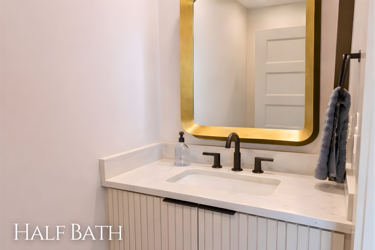 This half bath keeps things simple and stylish, with a modern vanity and clean finishes that make it a convenient and polished extra space.