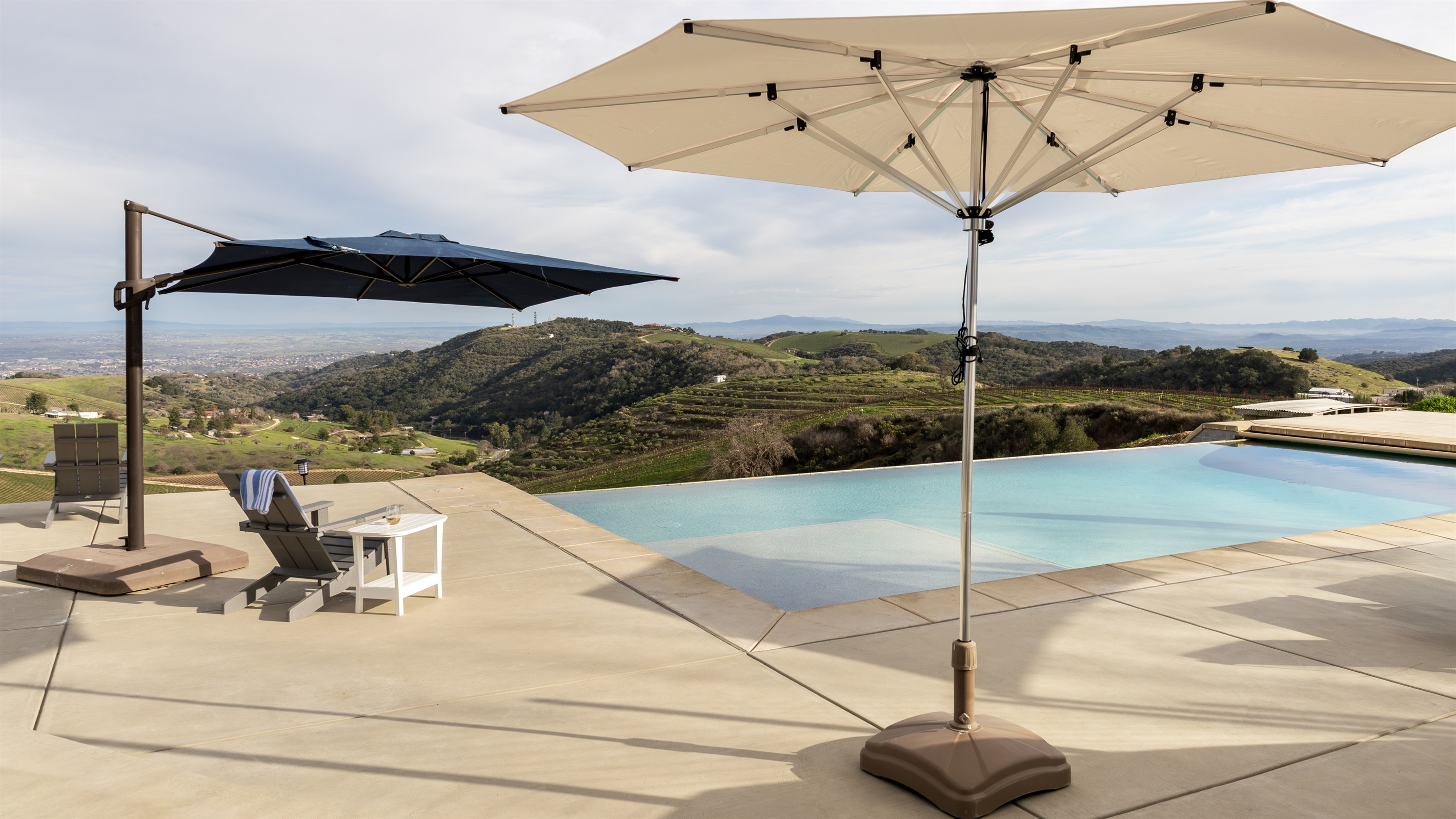 Shaded loungers, a sparkling infinity pool, and the whole Paso Robles valley stretching out to the horizon. The pool deck at the Hilltop Guest House is a destination all its own.