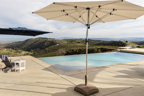 Shaded loungers, a sparkling infinity pool, and the whole Paso Robles valley stretching out to the horizon. The pool deck at the Hilltop Guest House is a destination all its own.