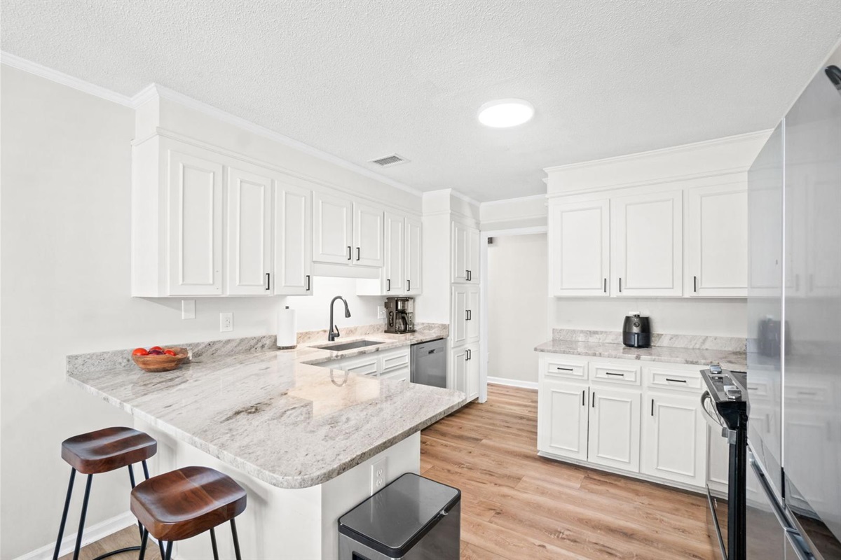 Kitchen with bar seating and all appliances