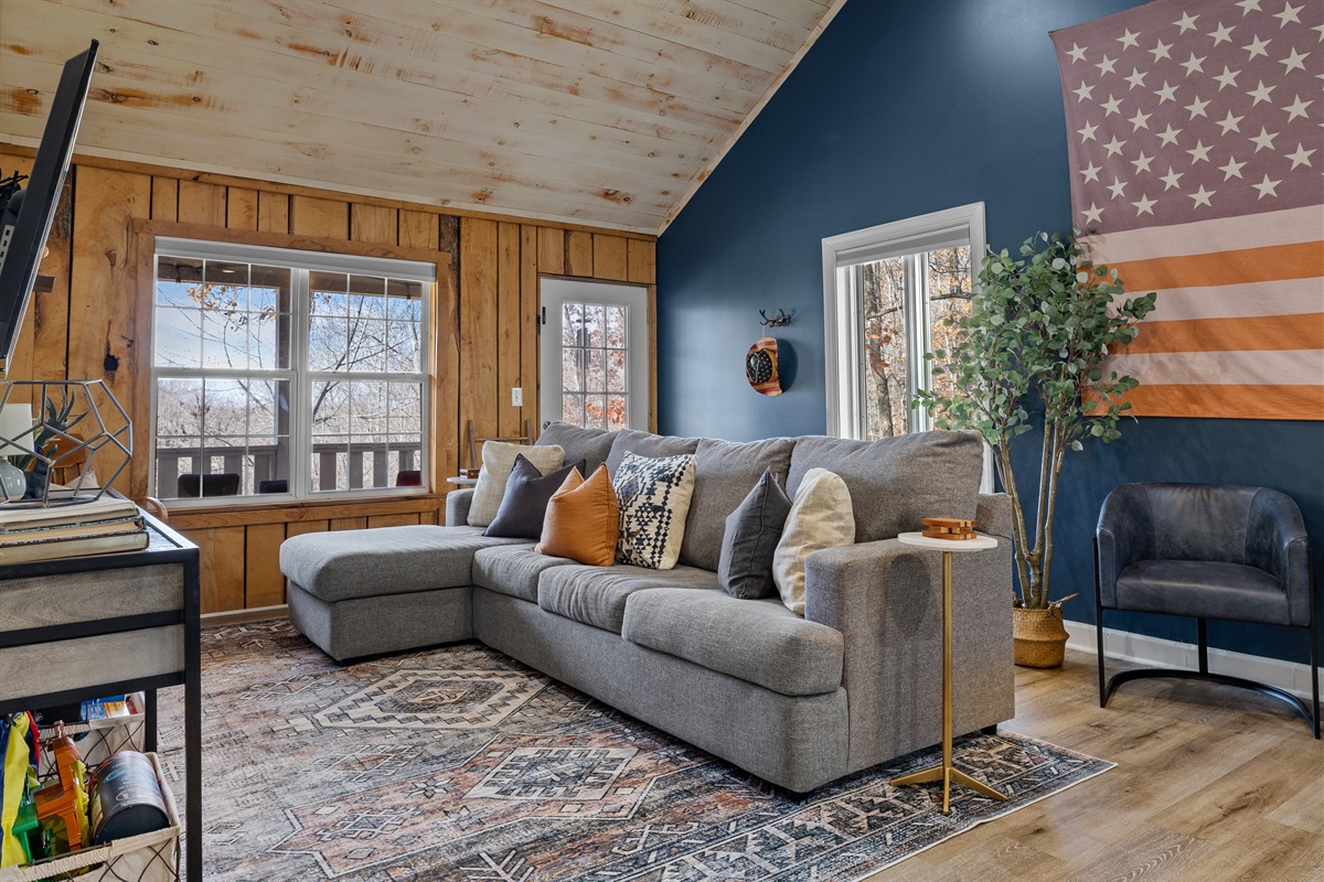 Back living room with cozy sectional that opens to queen sleeper bed.