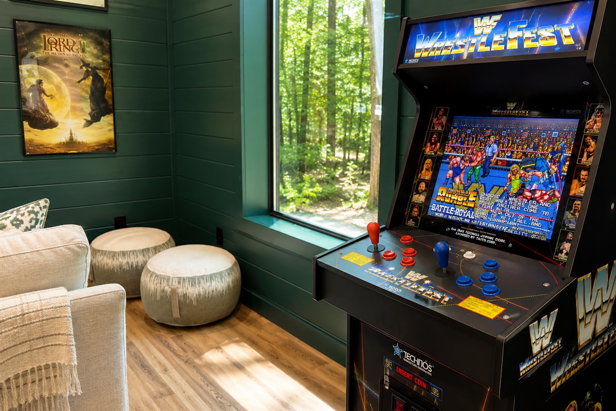 Game Room: Enjoy nostalgic gaming with a retro arcade cabinet and serene forest views!
