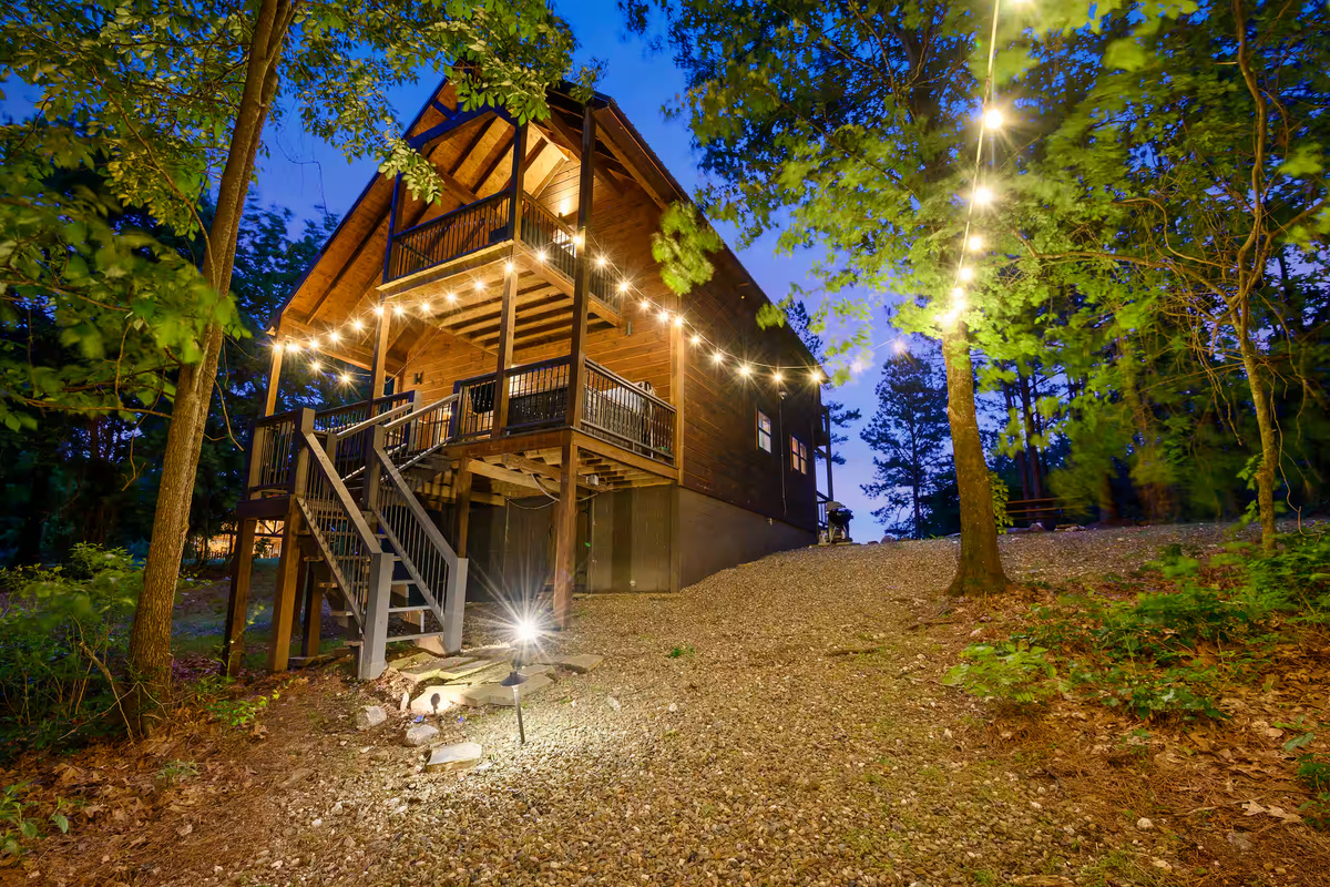 Exterior Retreat: Twinkling lights and charming nature await at this stunning woodland getaway!