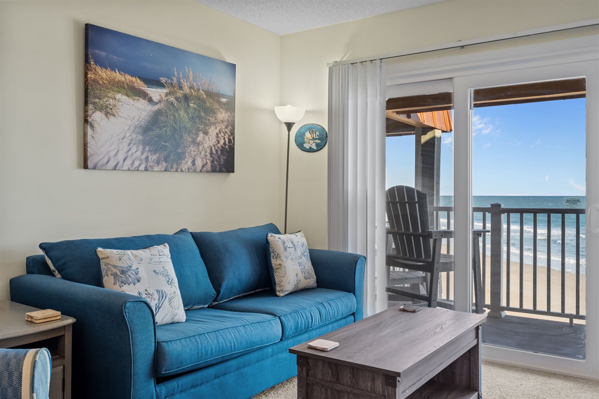 Coastal comfort meets ocean views&mdash;relax in the bright living area with direct access to the balcony and soothing sights of the sea