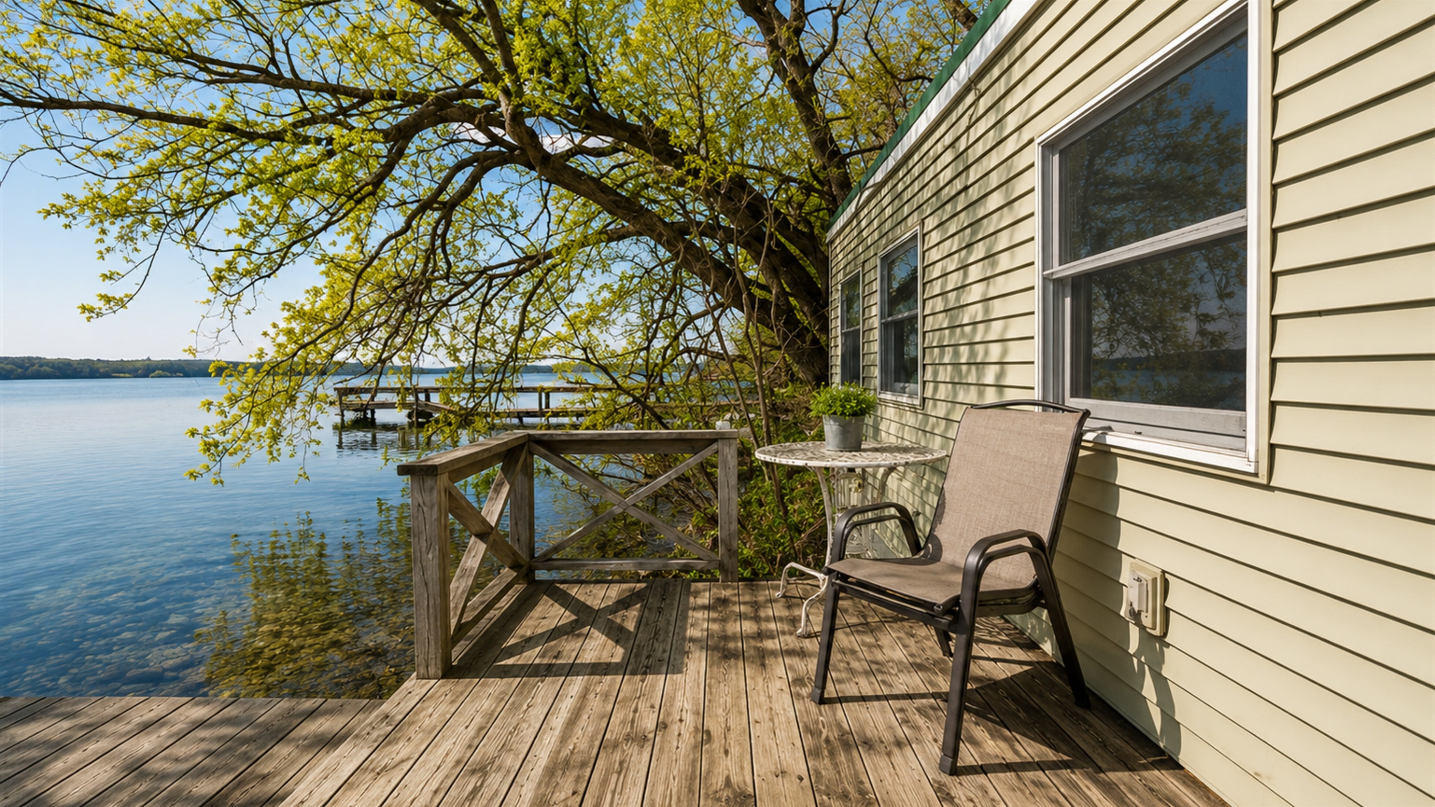 Lakefront / Boathouse / Dock (requires three flights of stairs to access) -  Savor the view from this charming lakeside deck, an inviting spot perfect for morning coffees or sunset gazing right on the water's edge.