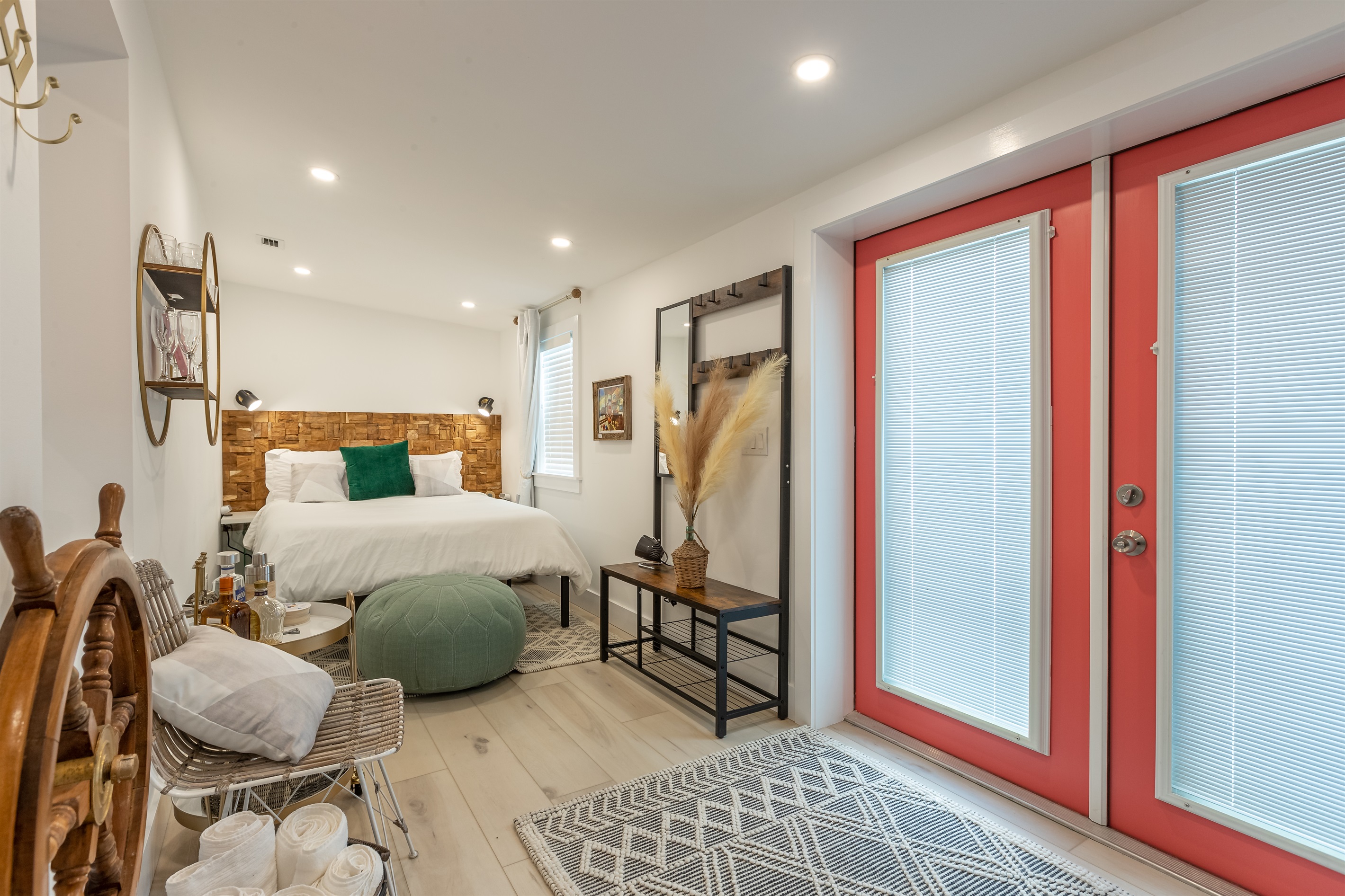 Charming Retreat: Stylish bedroom with coastal decor, vibrant accents, and inviting natural light!