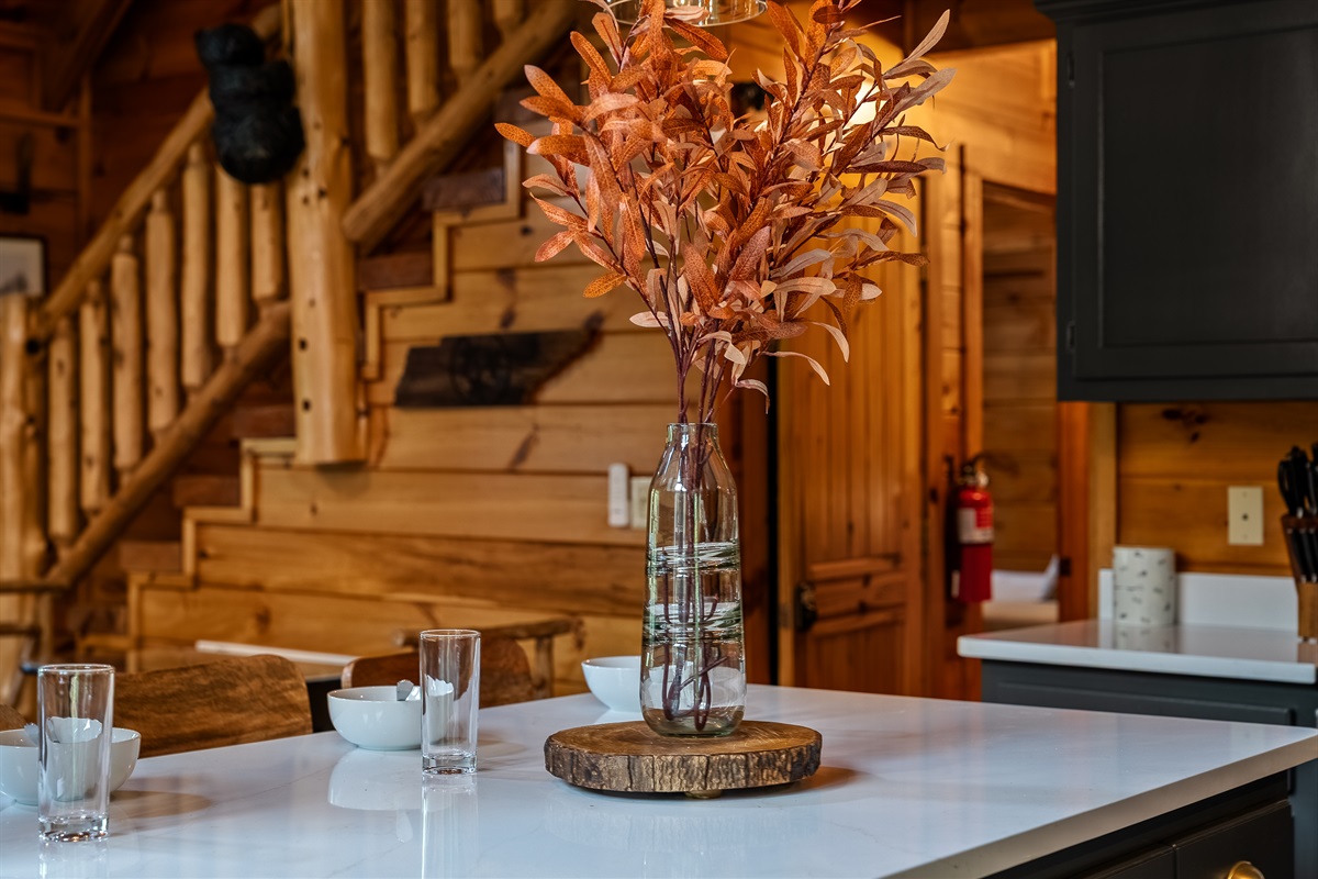 The warm wood tones, cozy cabin architecture, and thoughtfully styled décor create an inviting space to gather, dine, and reconnect after a day exploring the Smokies.