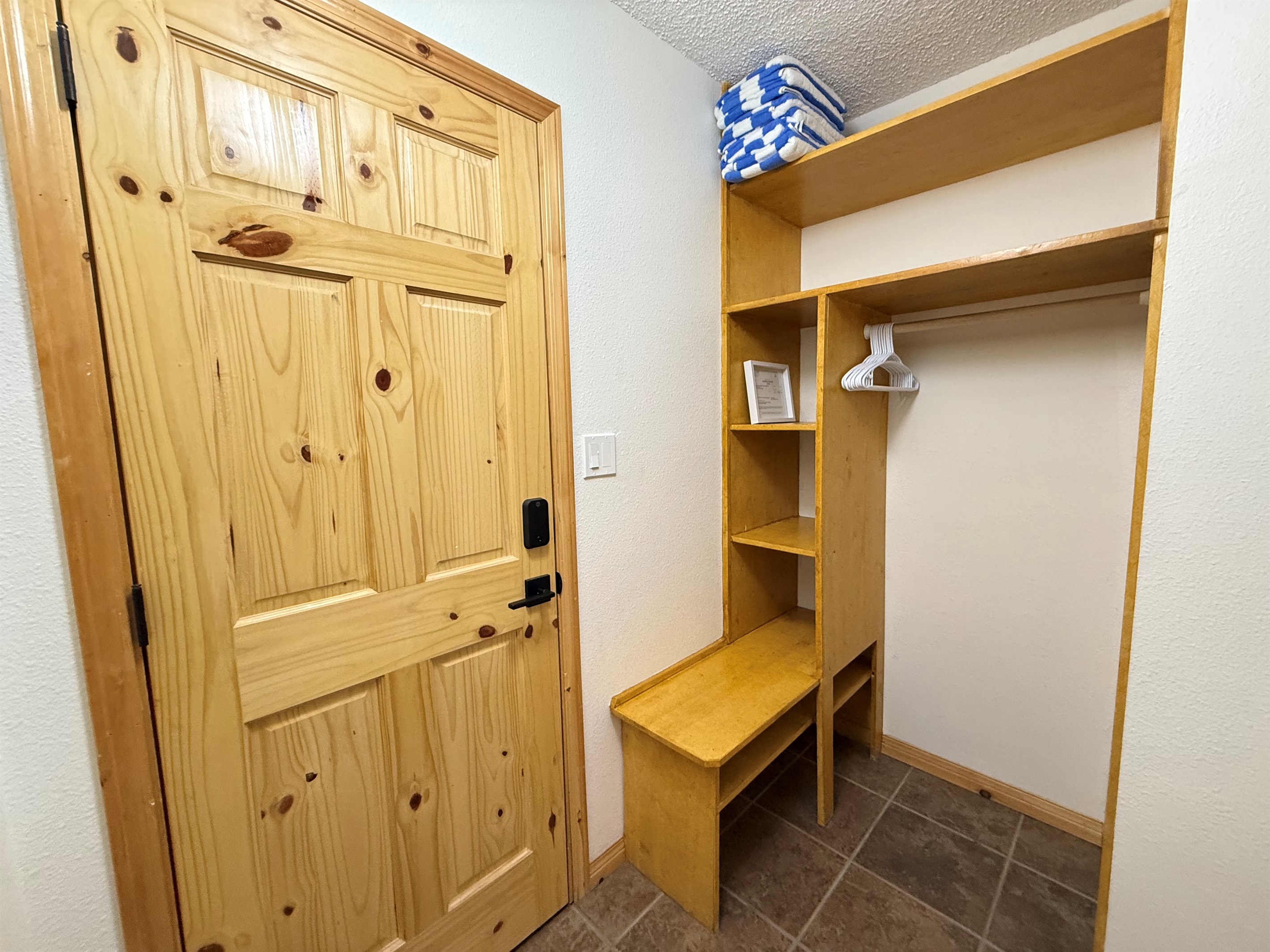 Gear Cubbies: Maximize organization with these built-in cubbies and shelving, providing dedicated storage for footwear, helmets, and gear right by the door. This is the deadbolted door to the Loft Suite. 
