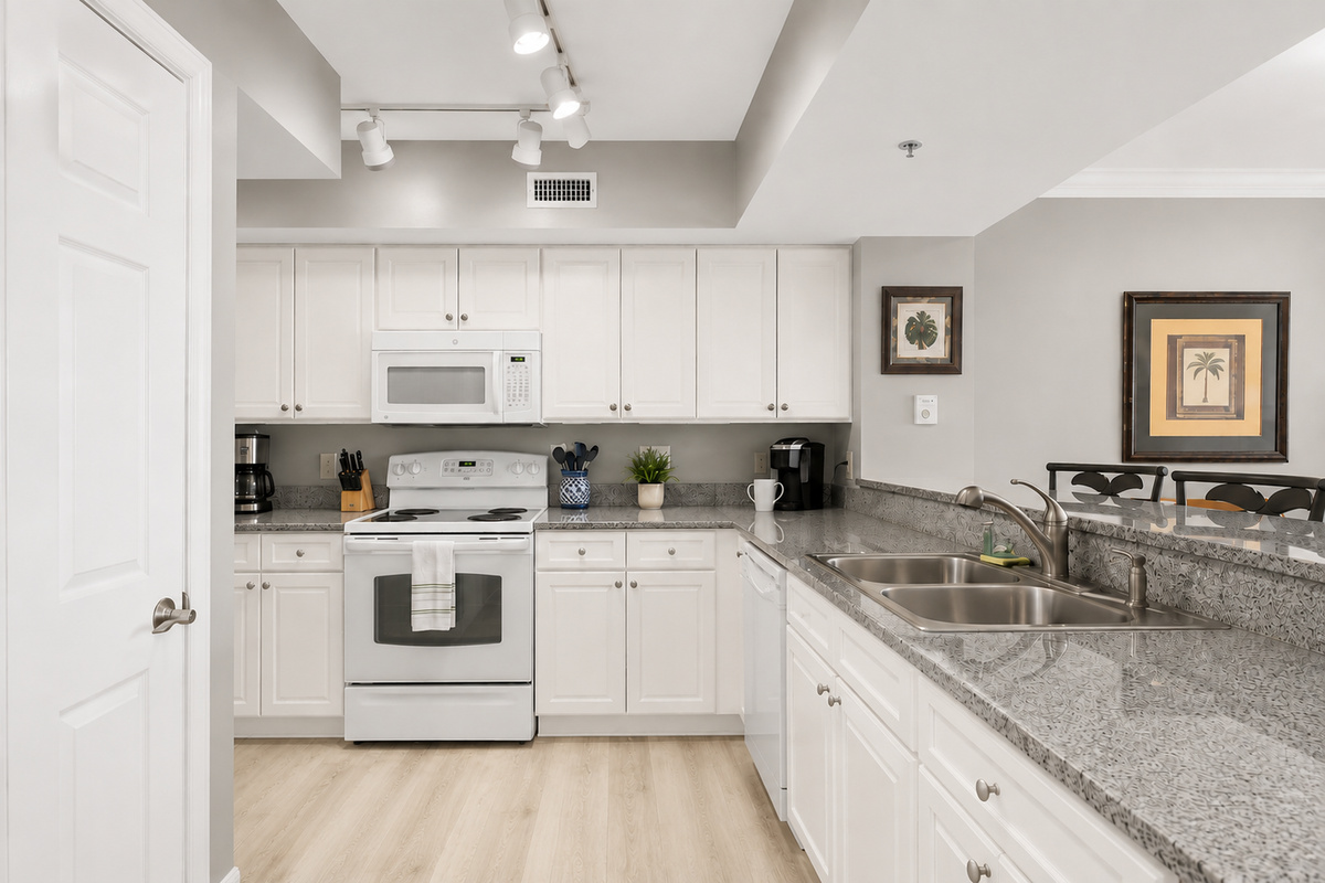 Fully-stocked kitchen, with pots, pans, blender, coffee maker, dishes, cups, mugs, and silverware