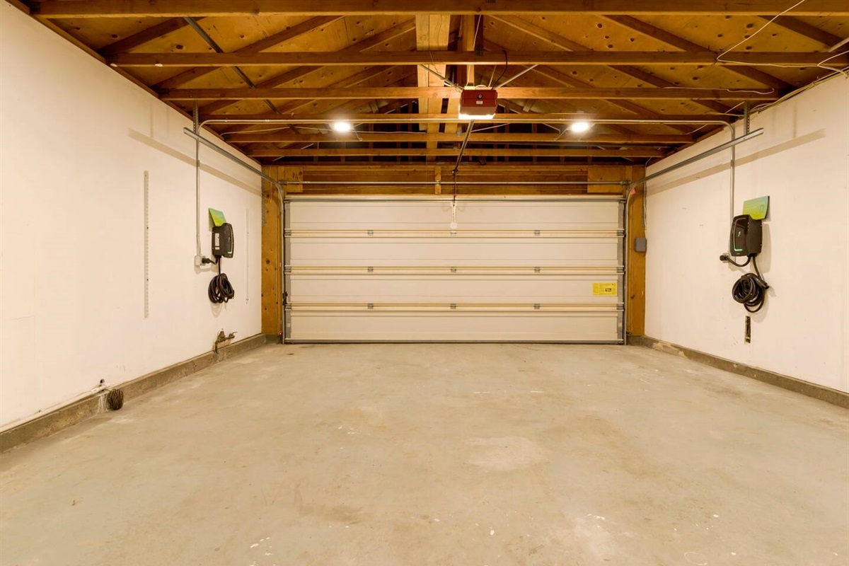 The garage is equipped with dual Level 2 EV chargers, allowing for fast and efficient charging of electric vehicles. Spacious and well-organized, it accommodates two cars and provides the convenience of simultaneous charging for eco-friendly driving.