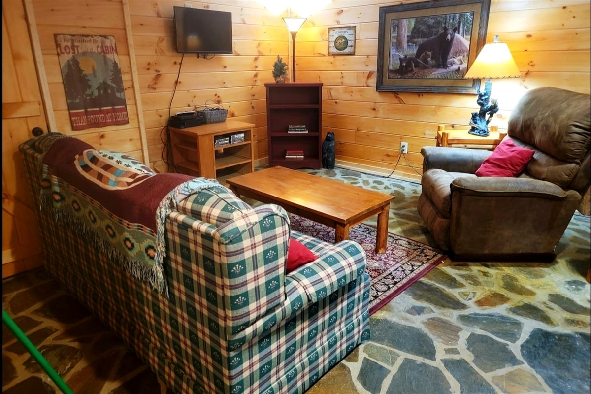 Lower level game room/ seating area with French Doors to lower level deck with log swing