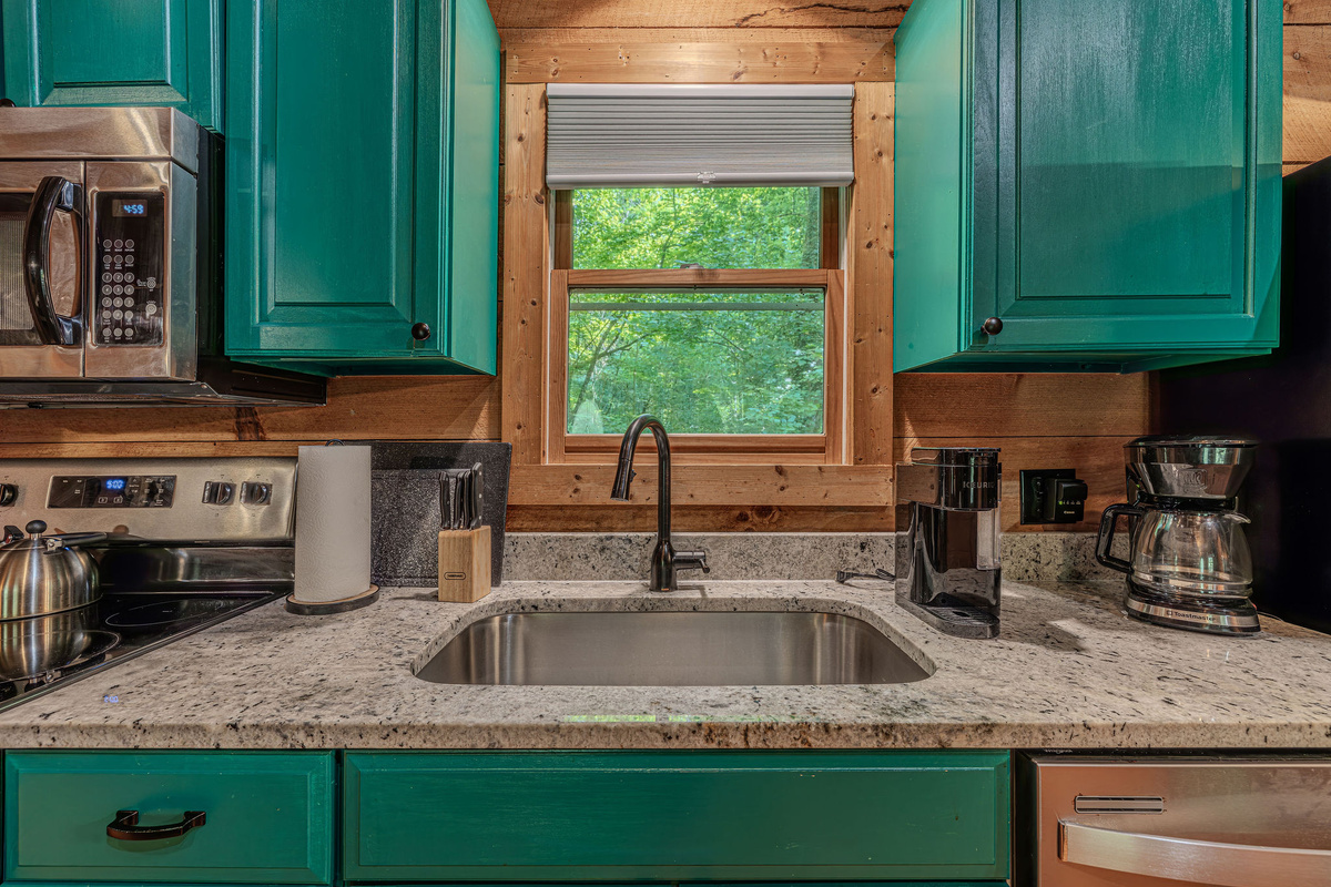 Teal cabinets, granite counters, fully loaded kitchen.