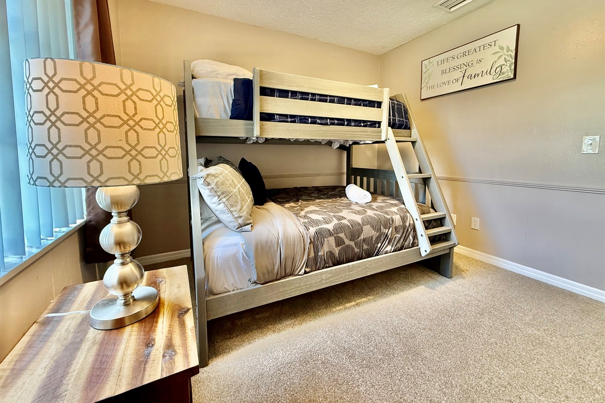 Give the little ones their own comfy corner with this cozy bunk room, complete with soft bedding, warm tones, and plenty of natural light.