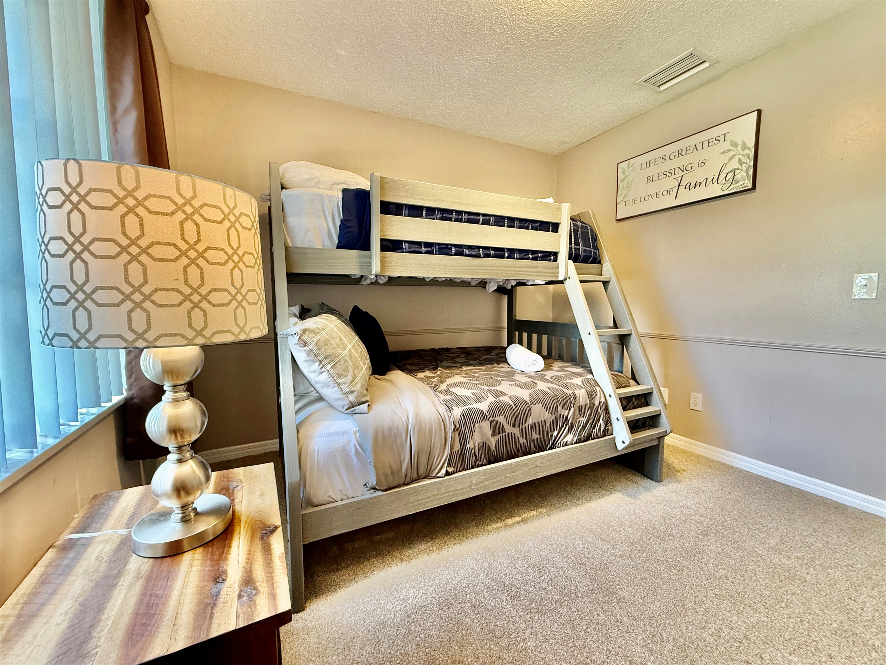 Give the little ones their own comfy corner with this cozy bunk room, complete with soft bedding, warm tones, and plenty of natural light.