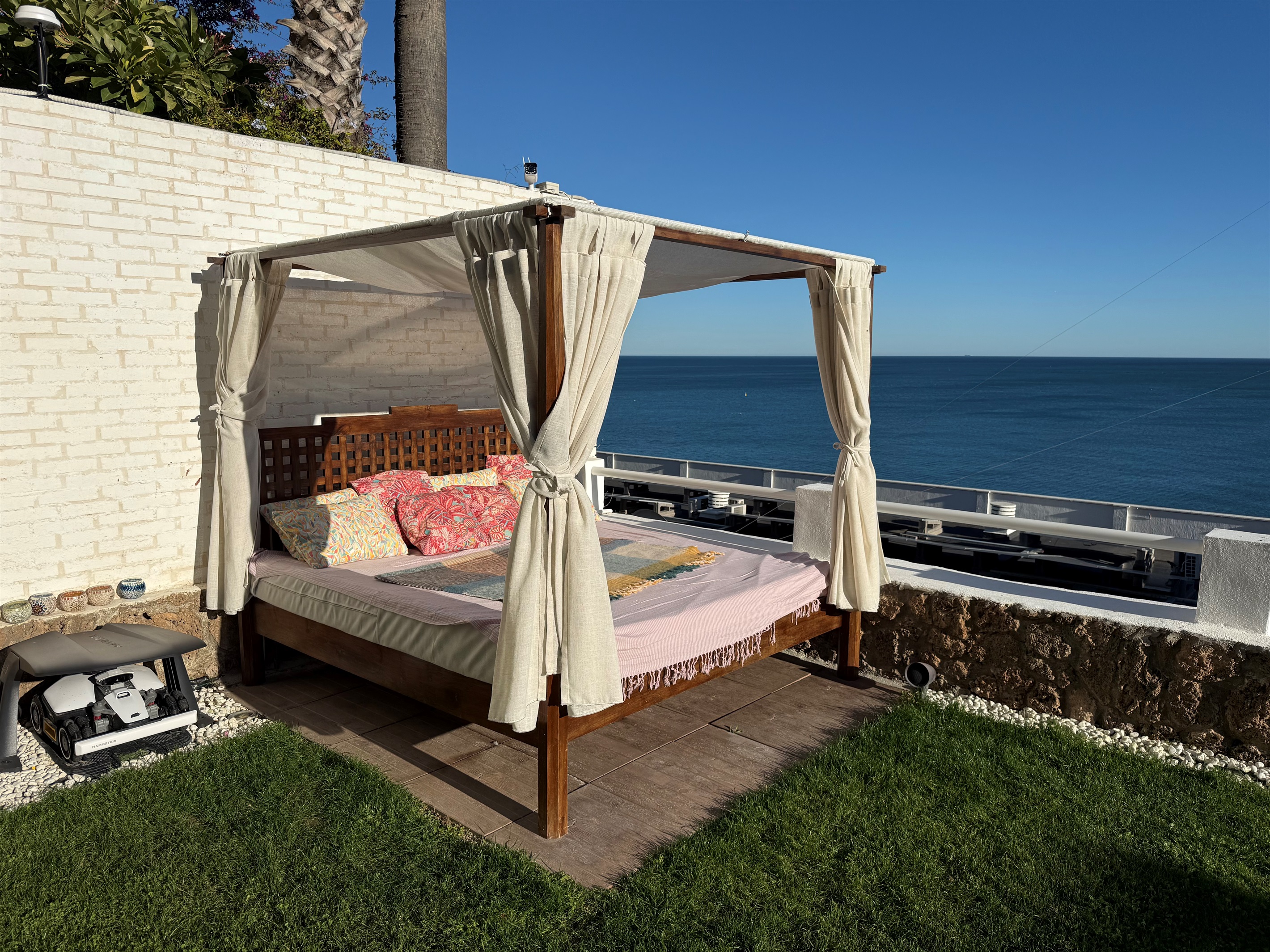 Private Balinese daybed with sea views, perfect for afternoon naps or evenings under the stars.
