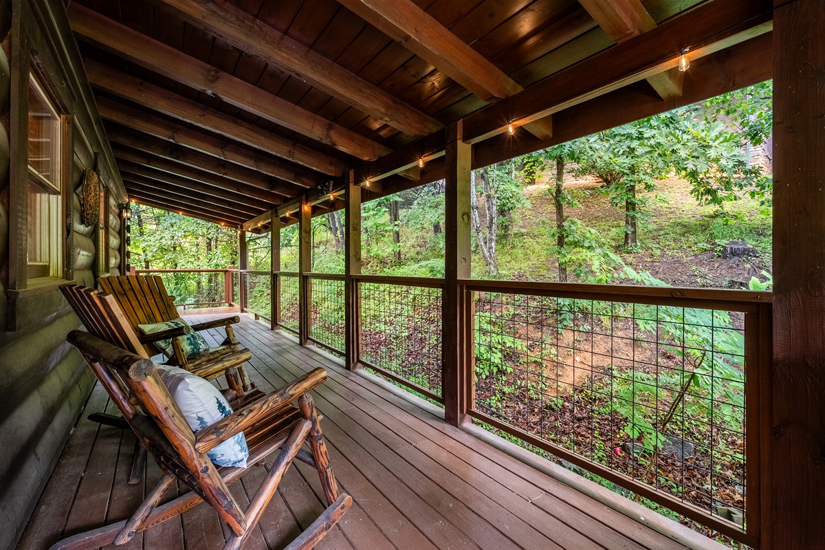 Unwind on the covered deck with classic rocking chairs; the perfect spot to sip your morning coffee or relax in the evening, all just steps from the front entry.
