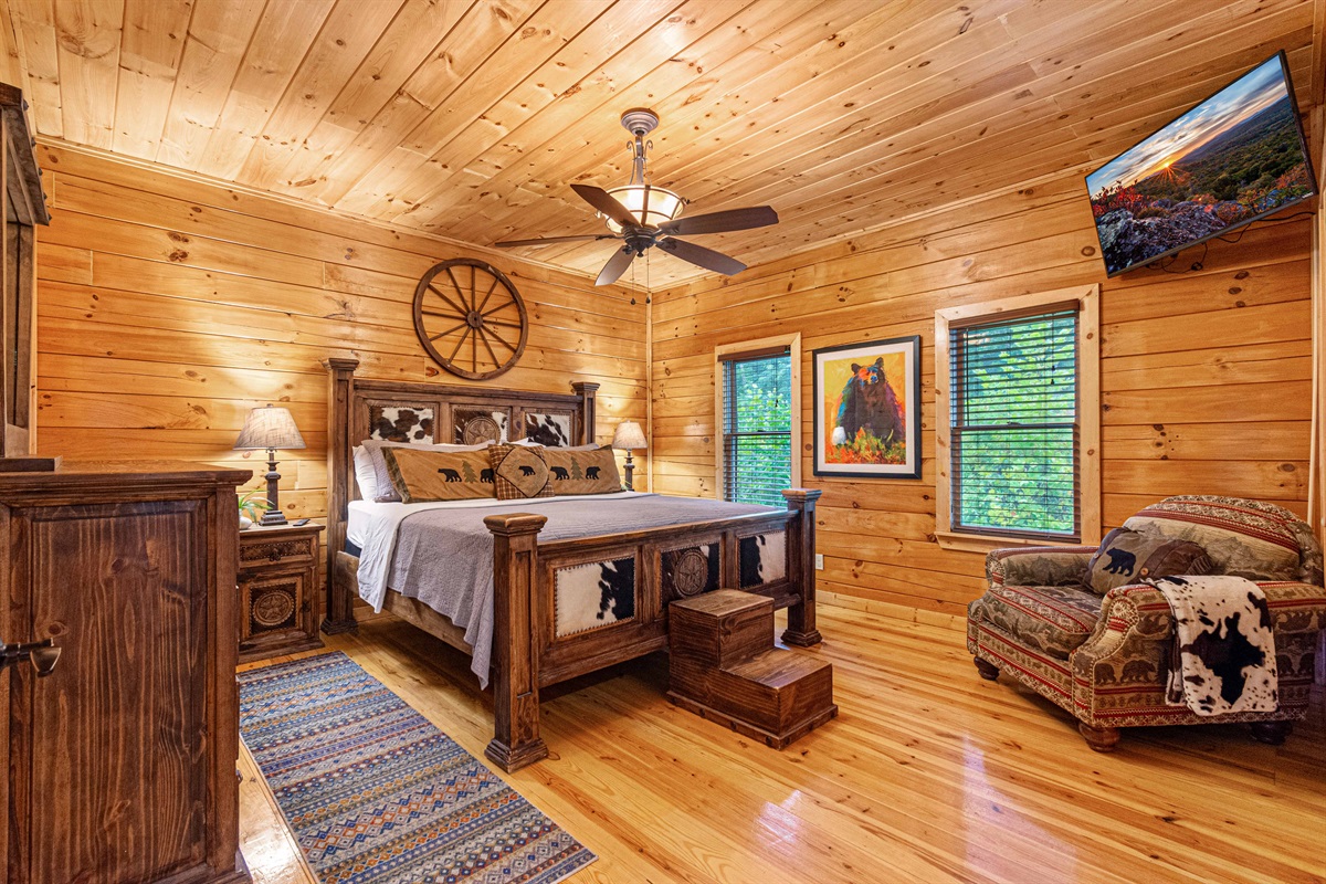 Rustic elegance. Unwind and relax in this beautifully appointed bedroom, complete with a king-size bed and cozy seating area.