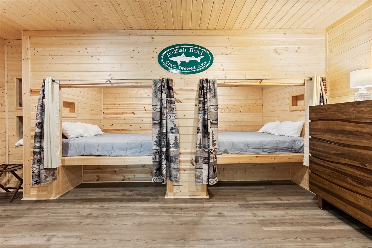 Lower-level open sleeping space featuring two cozy queen pods &mdash; perfect for group stays and extra guests.