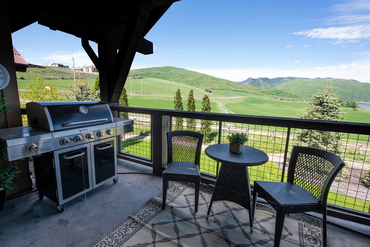 A private deck retreat where sweeping valley vistas set the stage for morning coffee or evening cocktails, complete with a built-in grill for effortless outdoor entertaining.