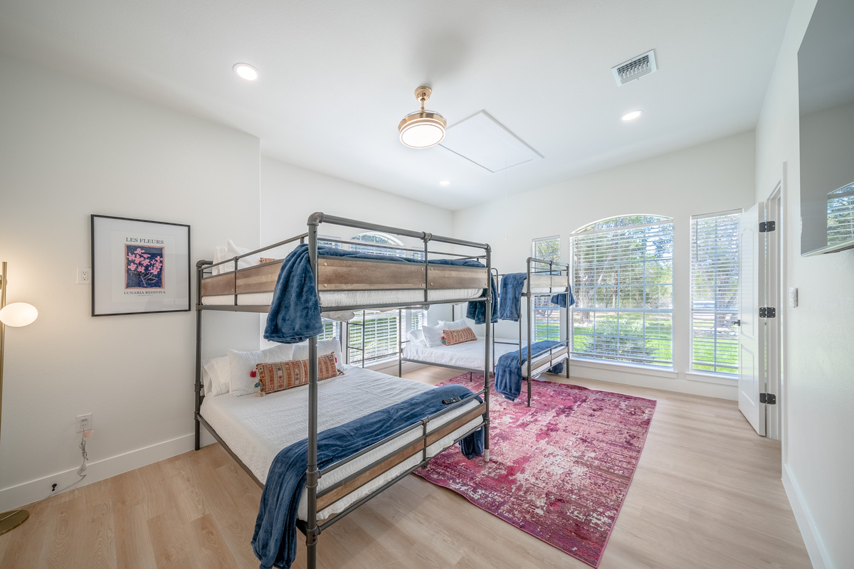 Bright bunk room with two Queen-over-Queen bunks — perfect for kids or groups