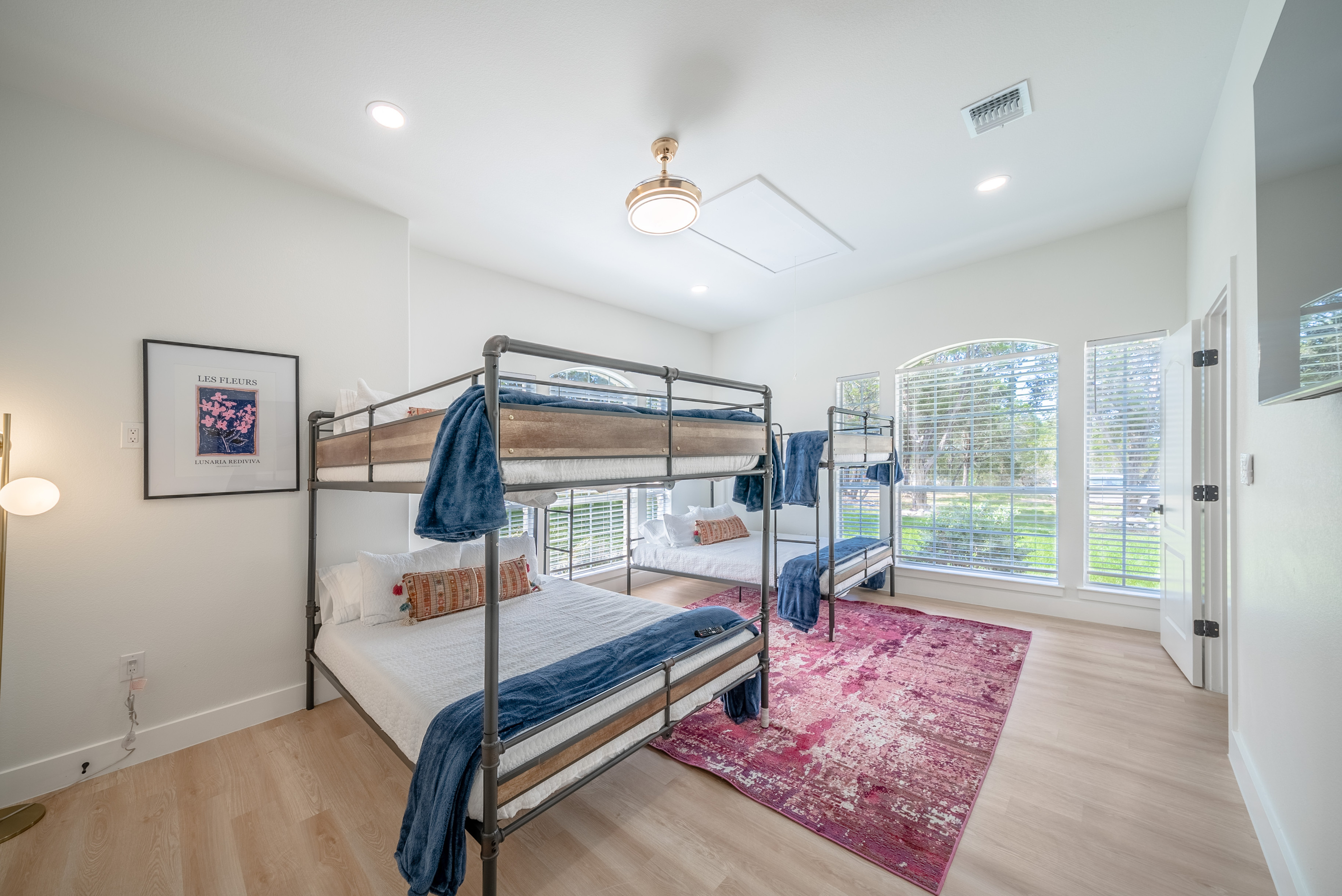 Bright bunk room with two Queen-over-Queen bunks — perfect for kids or groups