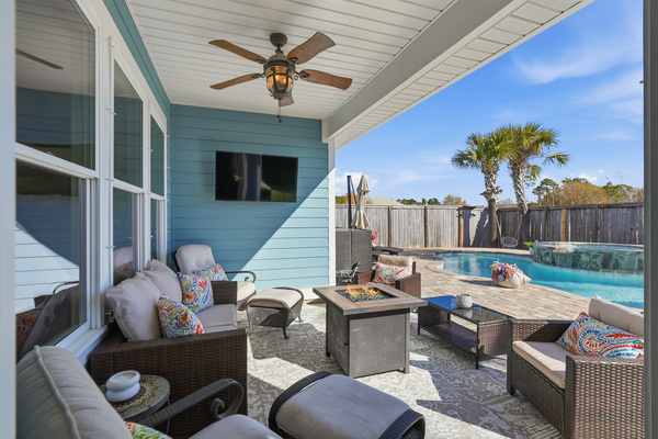Covered outdoor lounge and dining area beside the private pool—ideal for family vacations.