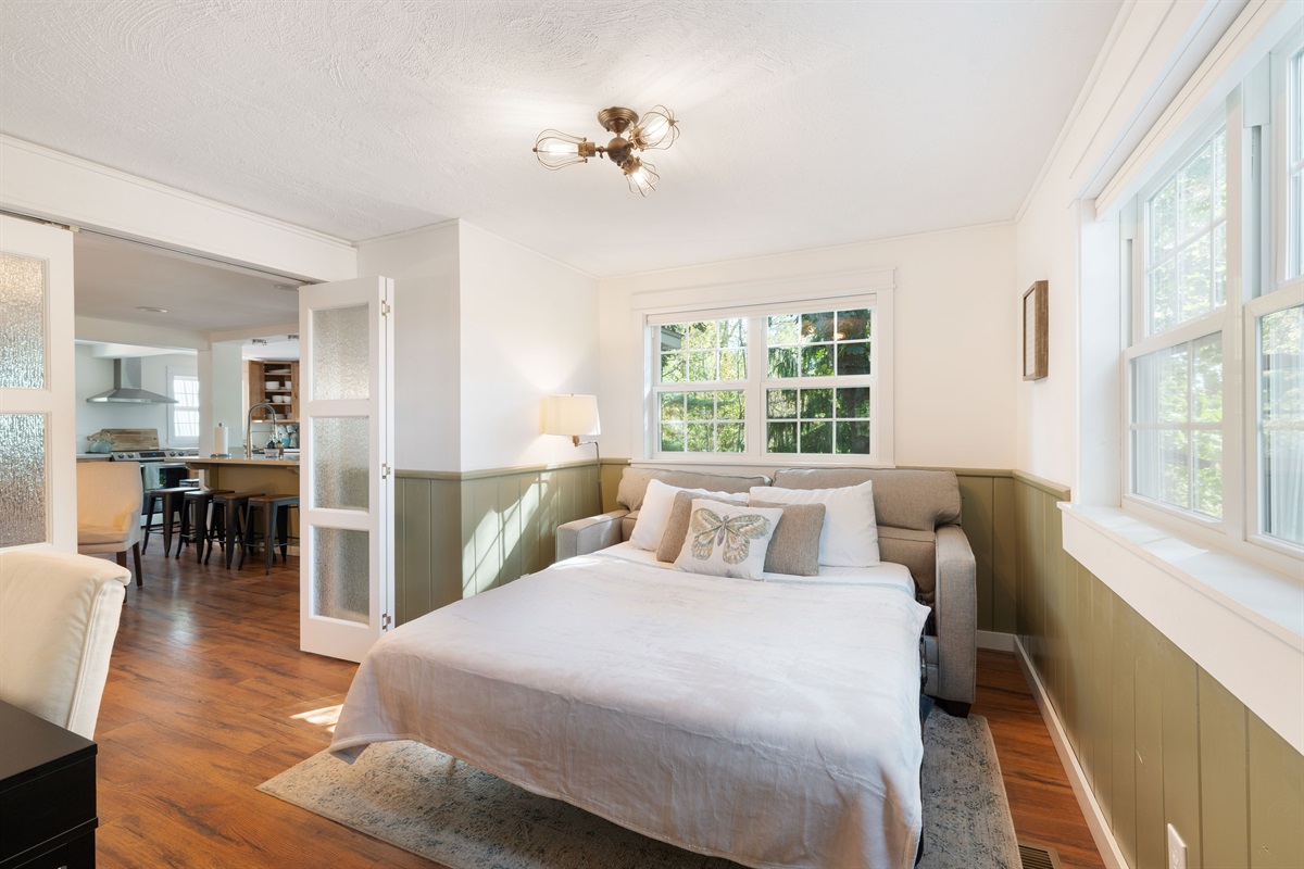 Glass doors provide privacy for individuals using the den for sleeping quarters.