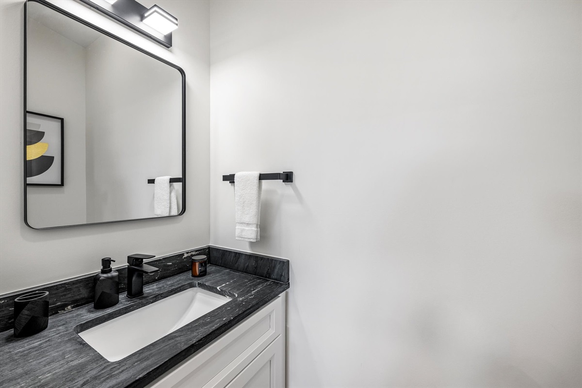 {Powder Bath} Clean, modern powder bath with vanity, mirror, and essentials — conveniently located for easy access from main living areas.