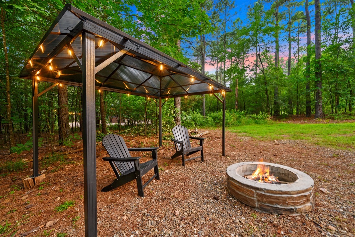 Outdoor Fire Pit Oasis: Unwind under twinkling lights by the fire with nature all around!