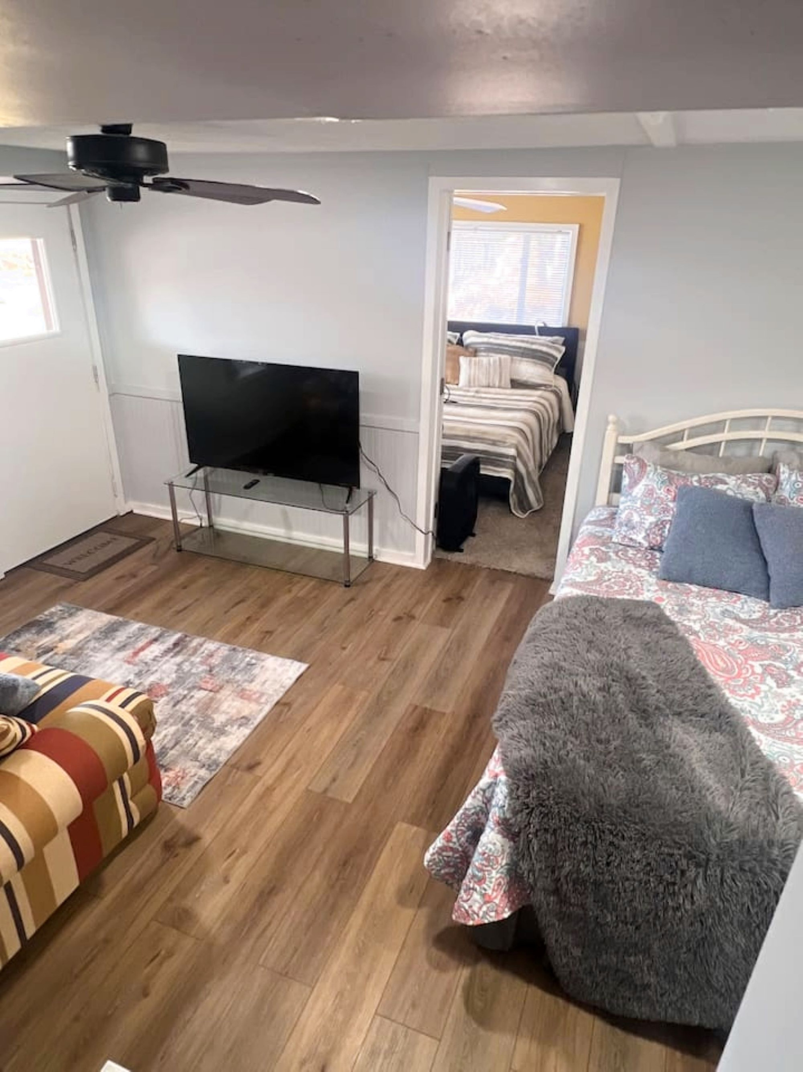The third bedroom is a converted common area that has been set up as a comfortable sleeping space. While it does not have a traditional enclosed bedroom layout, it provides a cozy and functional area ideal for additional guests. 
