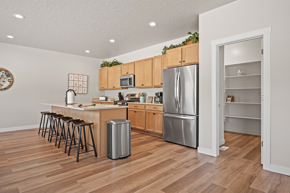 Tucked just off the kitchen, the walk-in pantry offers quick access to dry goods, cookware, and supplies.