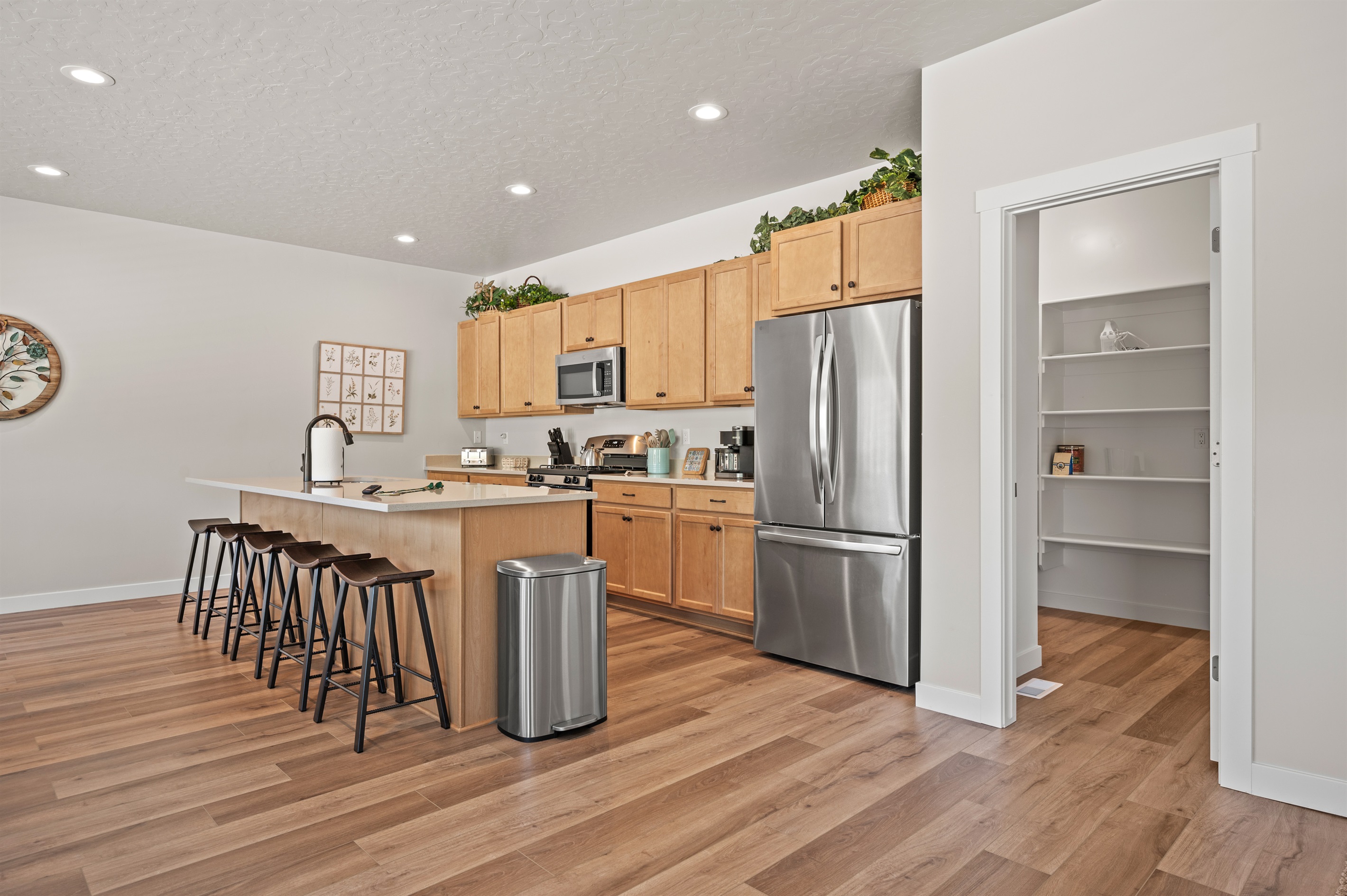 Tucked just off the kitchen, the walk-in pantry offers quick access to dry goods, cookware, and supplies.