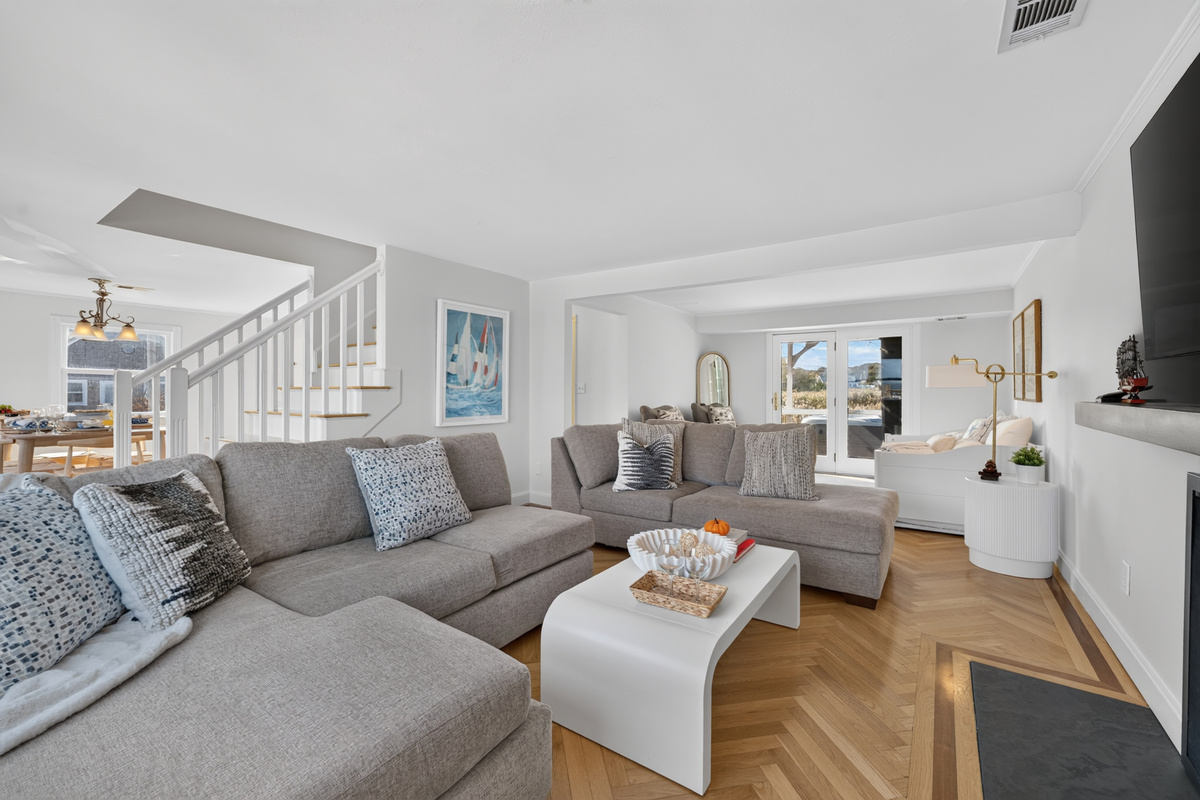 Spacious and airy living area designed for comfort, featuring ample seating and a seamless, open layout.