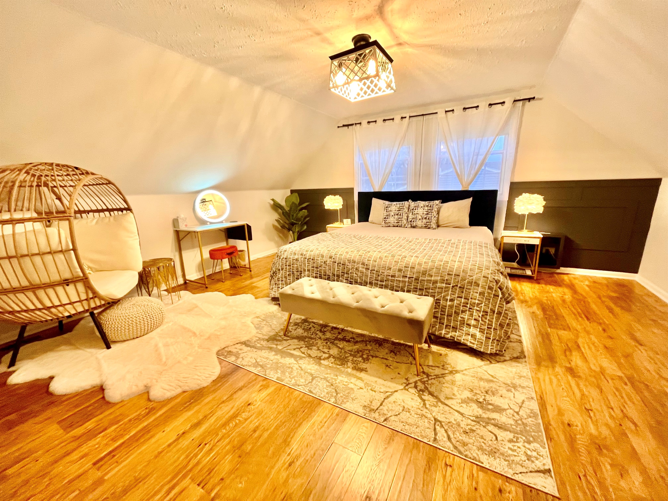 Beautiful upper master with king bed and egg chair make up table 