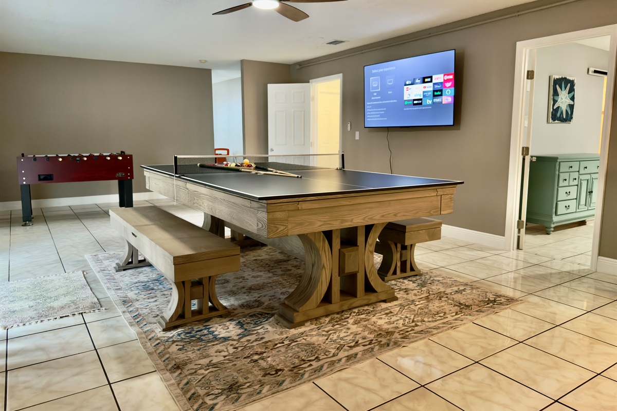 Mounted on the wall is a large flat-screen Smart TV, equipped with all the streaming favorites including Netflix, Hulu, Disney+, and more.