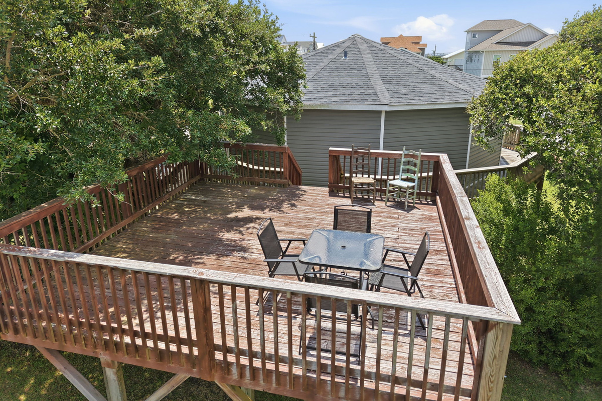 Elevated private sun deck with outdoor dining, perfect for relaxing, entertaining, or enjoying the coastal breeze