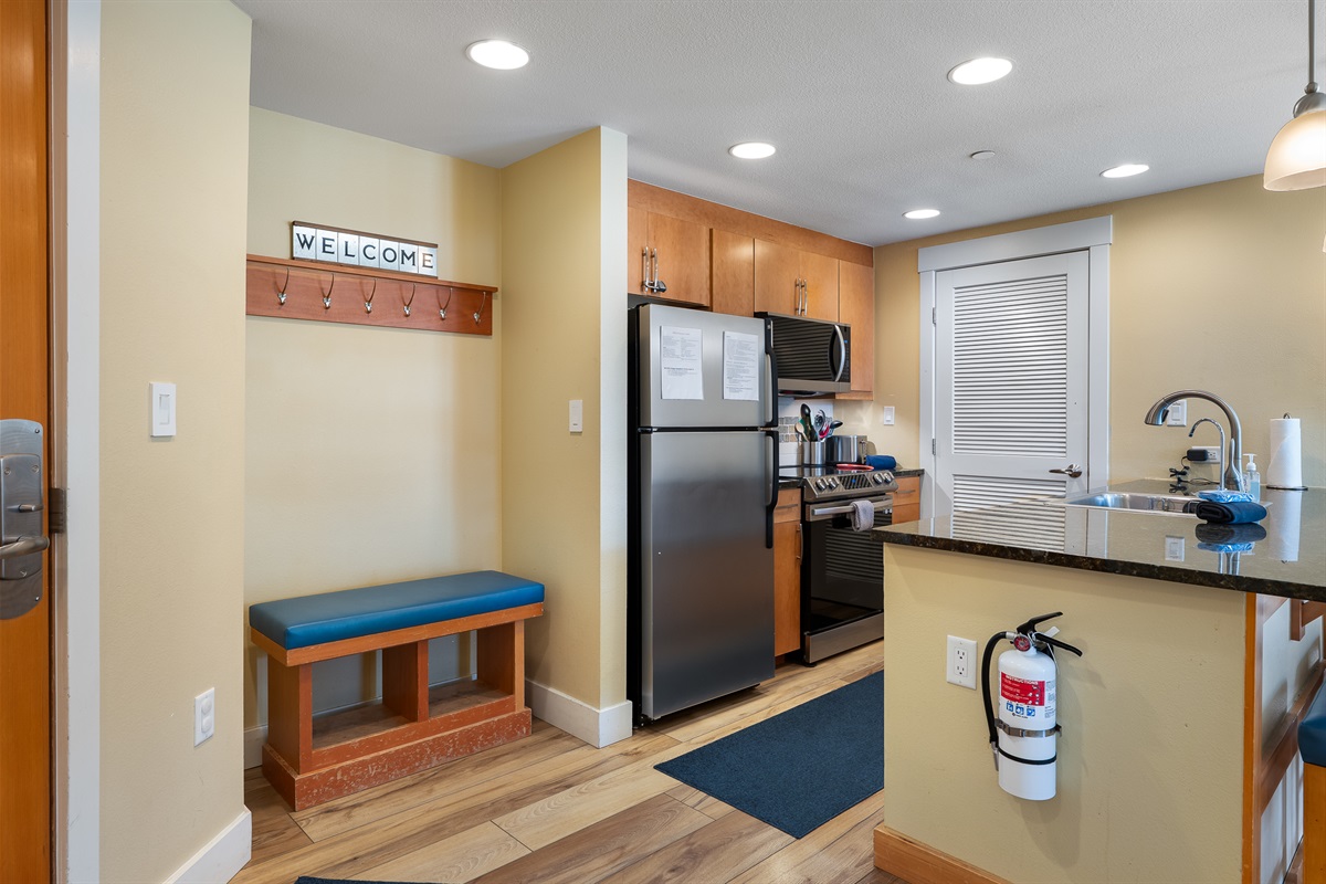 Coat hooks in entry with bench for putting on boots