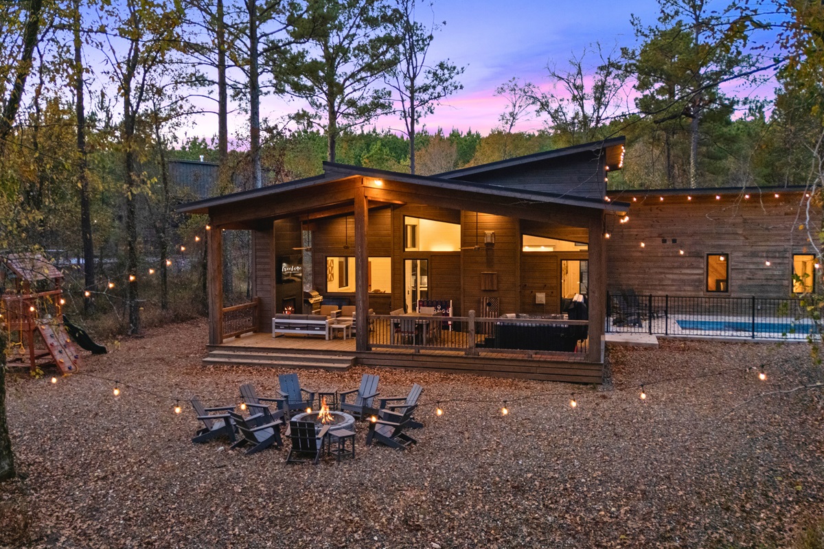 Enjoy the large backyard with fire pit, playground, pool, and hot tub.