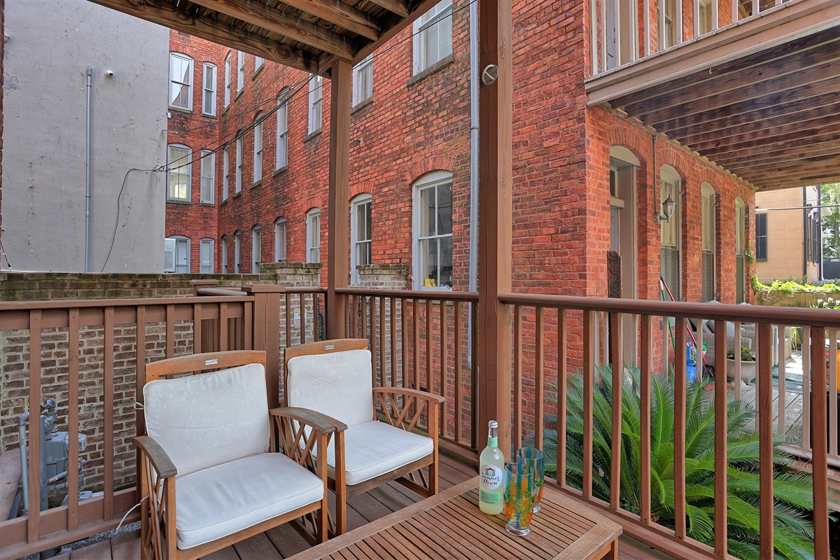 A cozy covered porch with plenty of room for friends or family to gather.