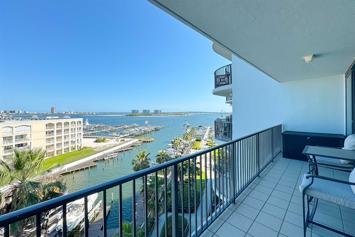 Experience the beauty of indoor-outdoor living with expansive sliding doors leading to a private balcony overlooking the bay.